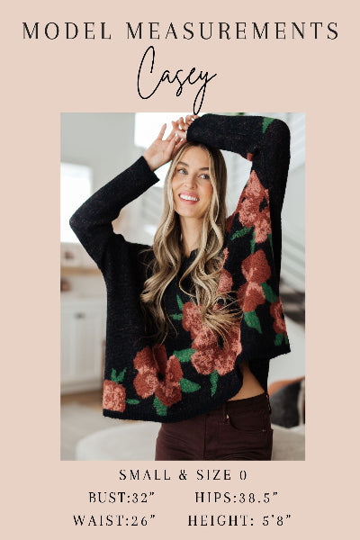 Casey wearing a floral sweater with model measurements displayed.