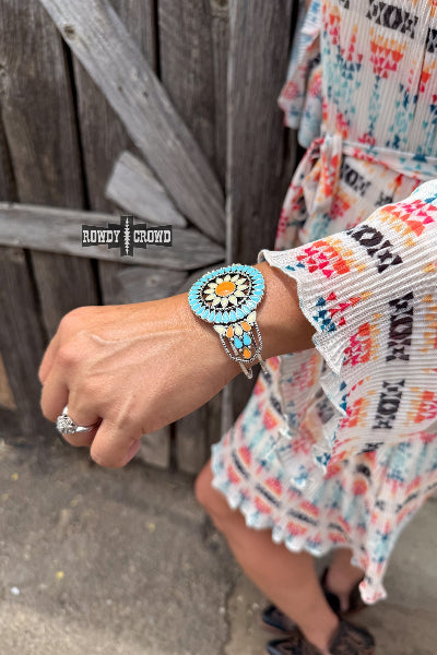 Close-up of a person wearing a colorful bracelet with a wooden background