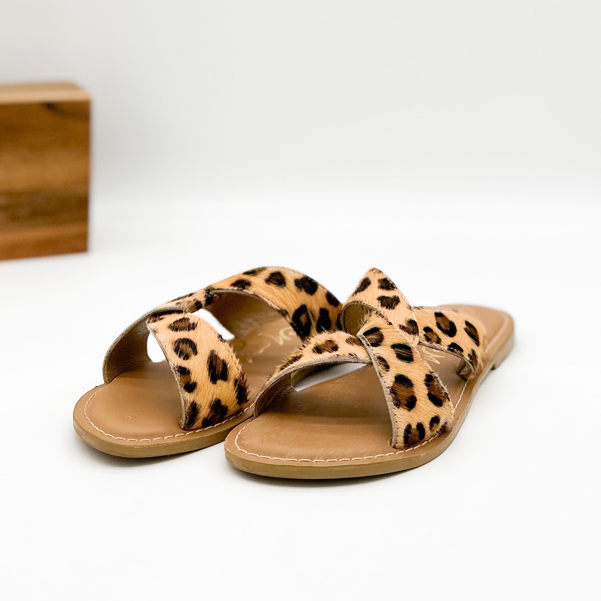 Leopard print sandals on a white background