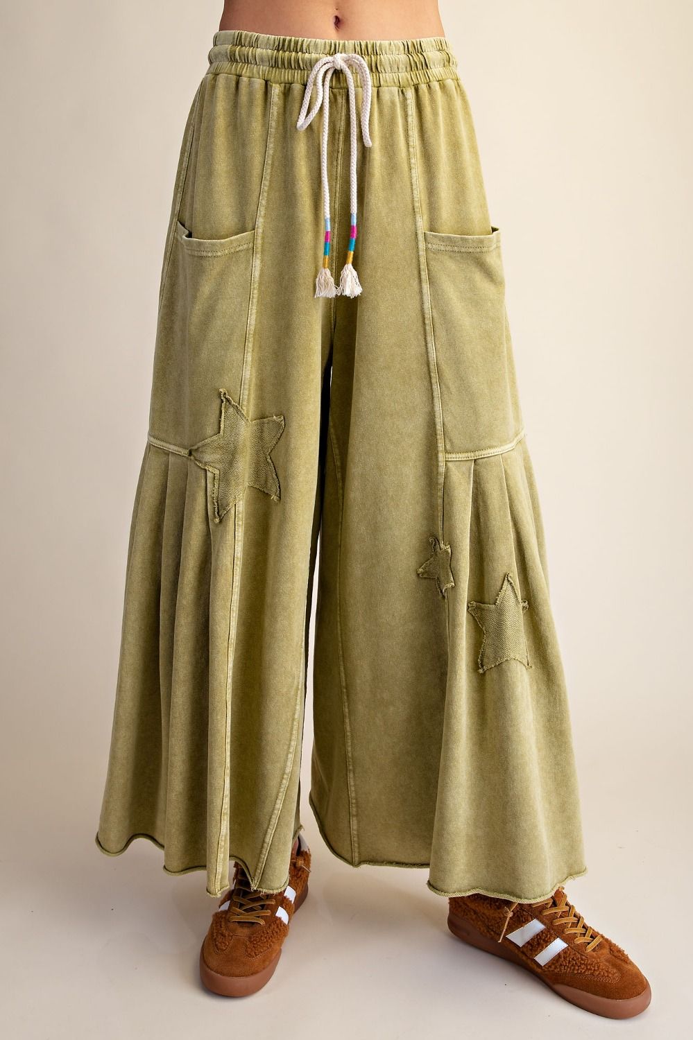 Woman wearing Pistachio star patch mineral wash pants.