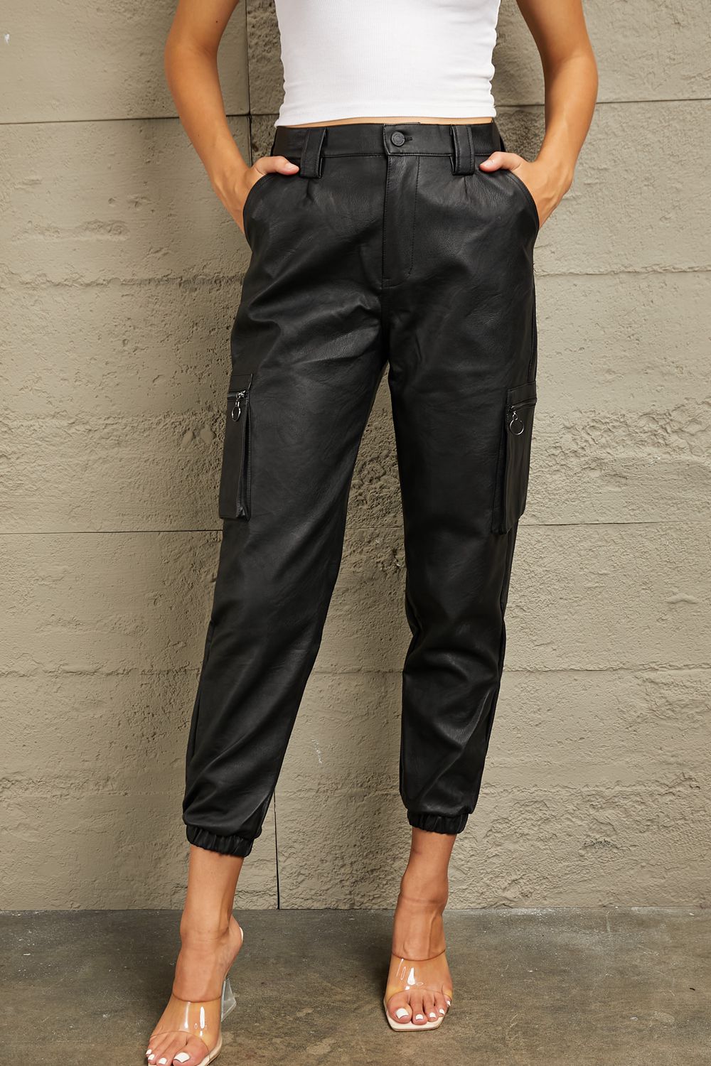 These joggers boast a high-rise waist that flatters your silhouette and provides a comfortable fit. The luxurious leather adds a touch of edge to your ensemble, whether you're dressing up for a night out or adding a chic twist to your everyday look. With a relaxed jogger silhouette and a high-fashion edge, these leather joggers are a versatile must-have for any fashion-forward wardrobe.