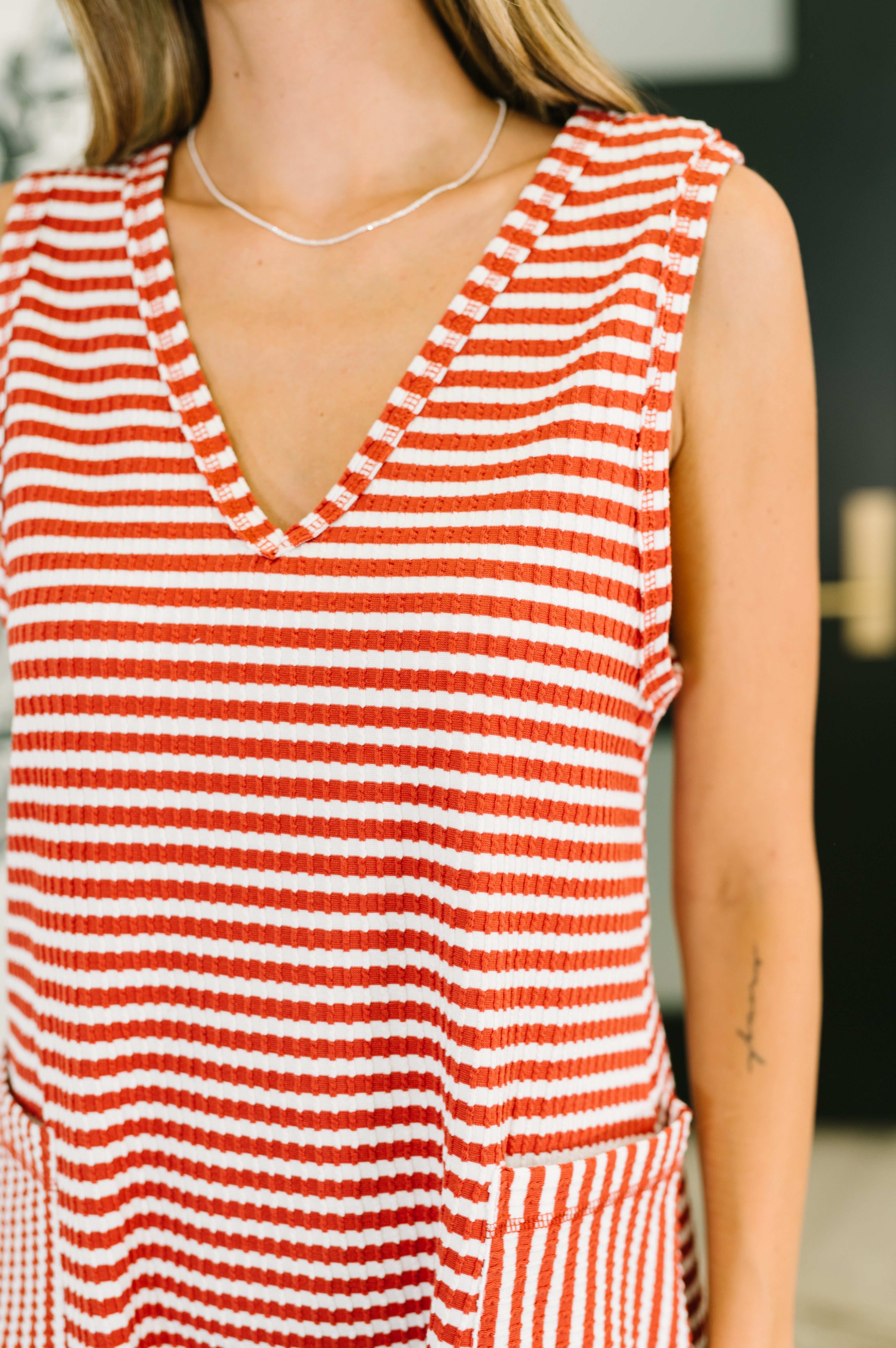 Close-up of cable ribbed texture and neckline detail on knit romper