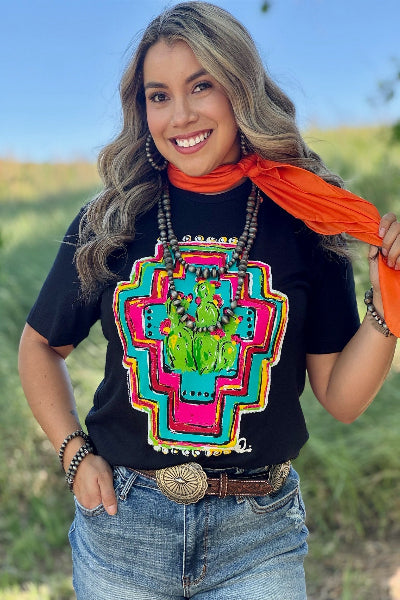 Woman wearing a black t-shirt with a colorful graphic design outdoors