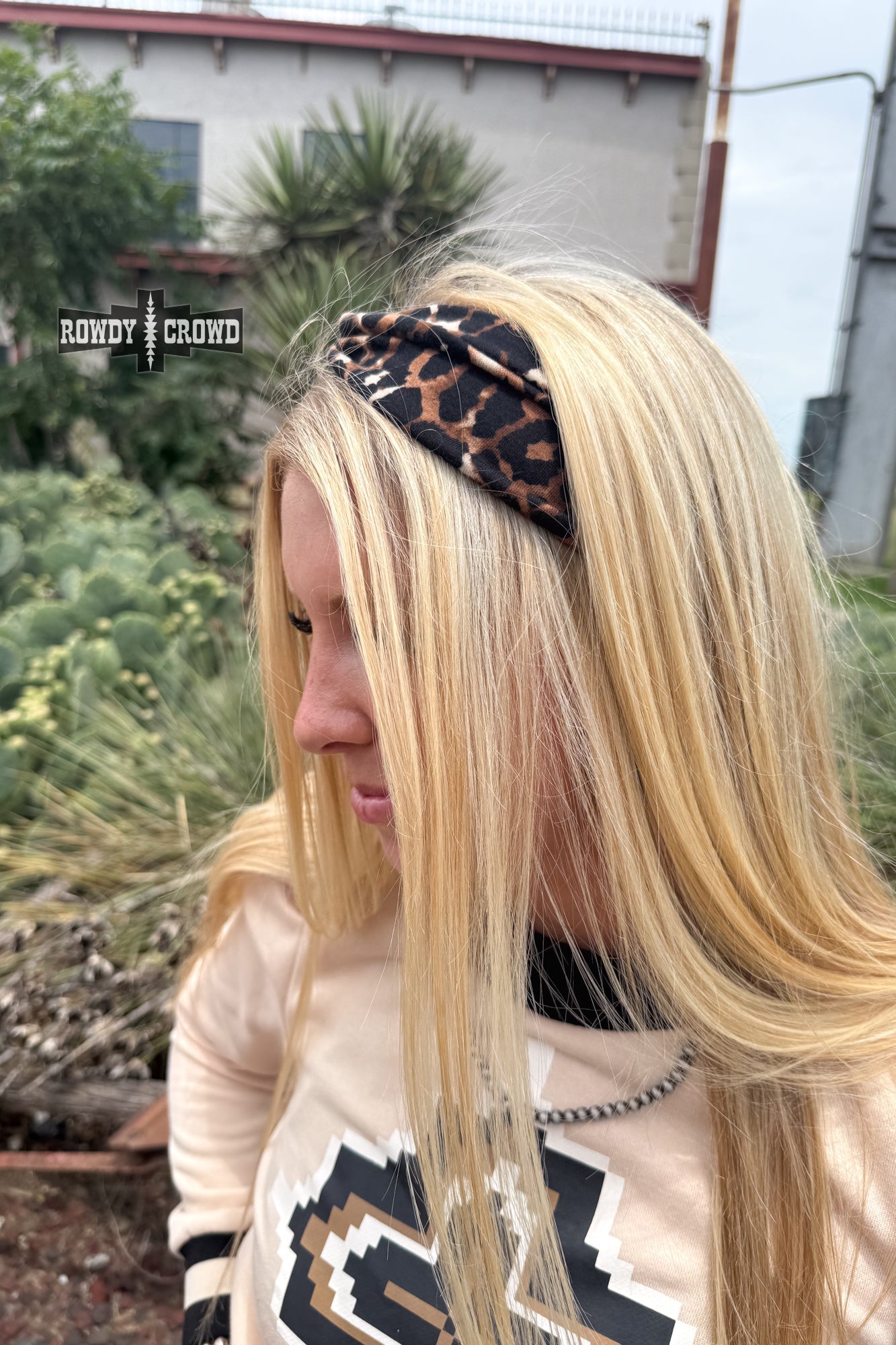 Woman wearing a leopard print headband with a blurred background