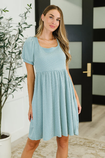 Model wearing Twirlin' Dirty cable ribbed knit dress with balloon sleeves and square neckline
