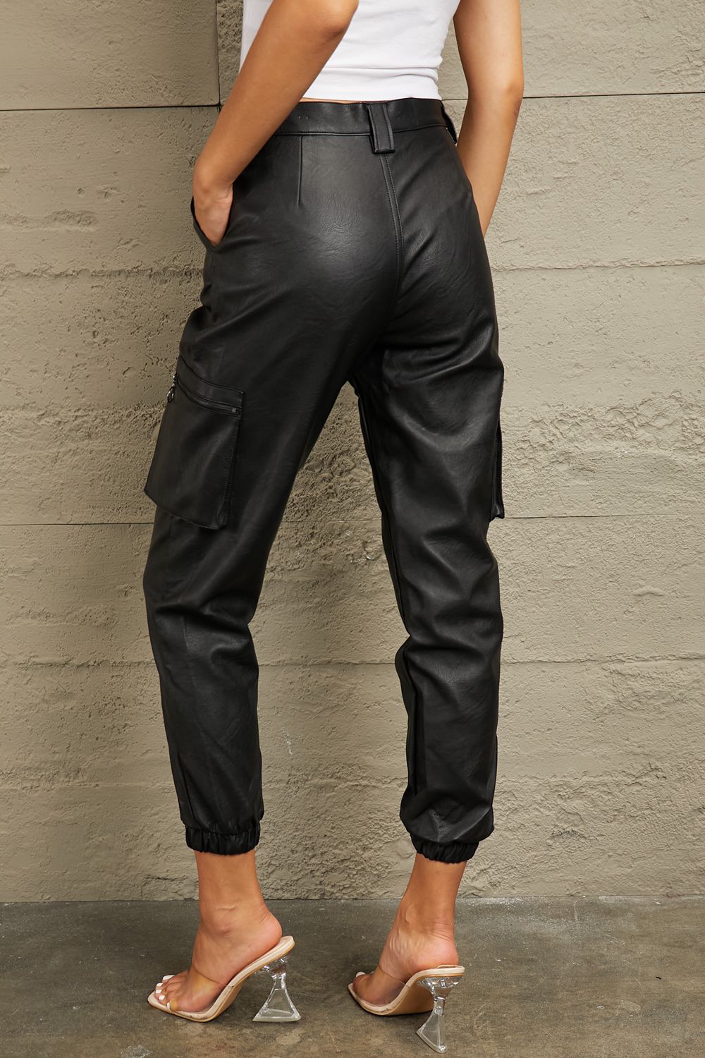 These joggers boast a high-rise waist that flatters your silhouette and provides a comfortable fit. The luxurious leather adds a touch of edge to your ensemble, whether you're dressing up for a night out or adding a chic twist to your everyday look. With a relaxed jogger silhouette and a high-fashion edge, these leather joggers are a versatile must-have for any fashion-forward wardrobe.