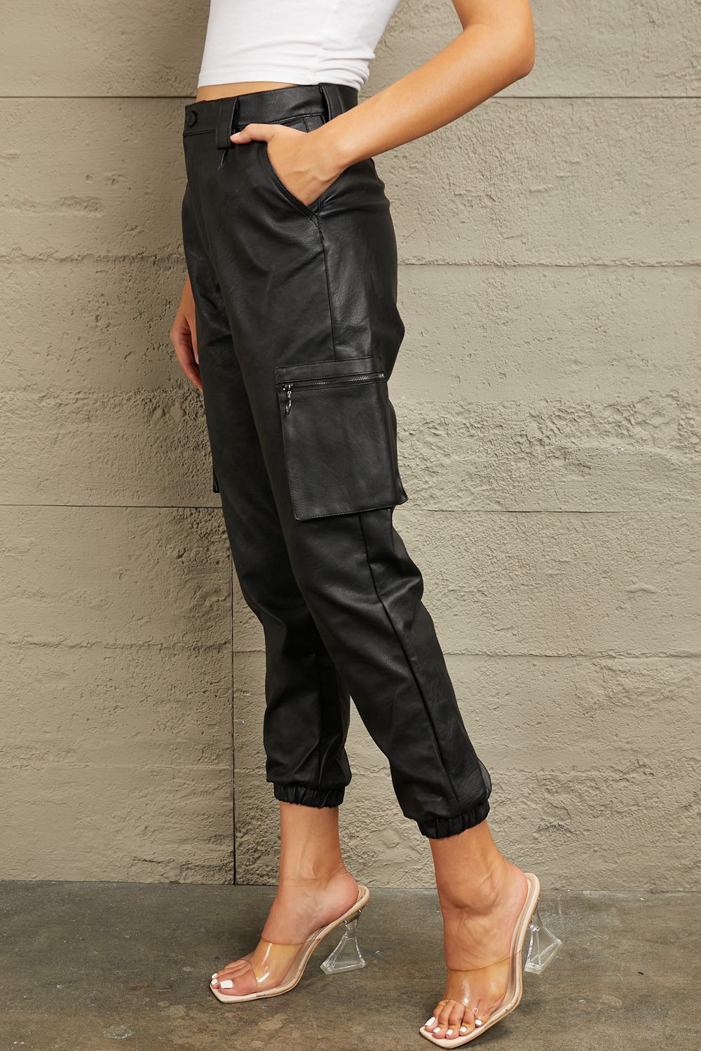 These joggers boast a high-rise waist that flatters your silhouette and provides a comfortable fit. The luxurious leather adds a touch of edge to your ensemble, whether you're dressing up for a night out or adding a chic twist to your everyday look. With a relaxed jogger silhouette and a high-fashion edge, these leather joggers are a versatile must-have for any fashion-forward wardrobe.